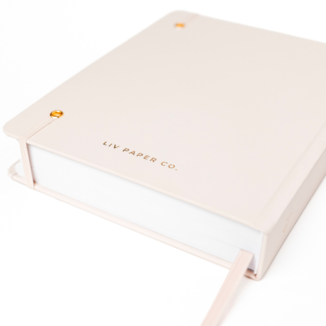 Beige notebook with 'LIV PAPER CO.' branding on a white background