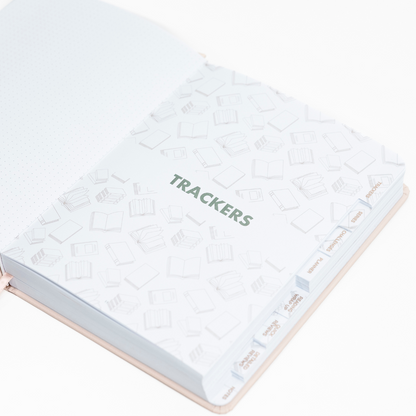 Undated Reading Journal with 'Trackers' on a white background